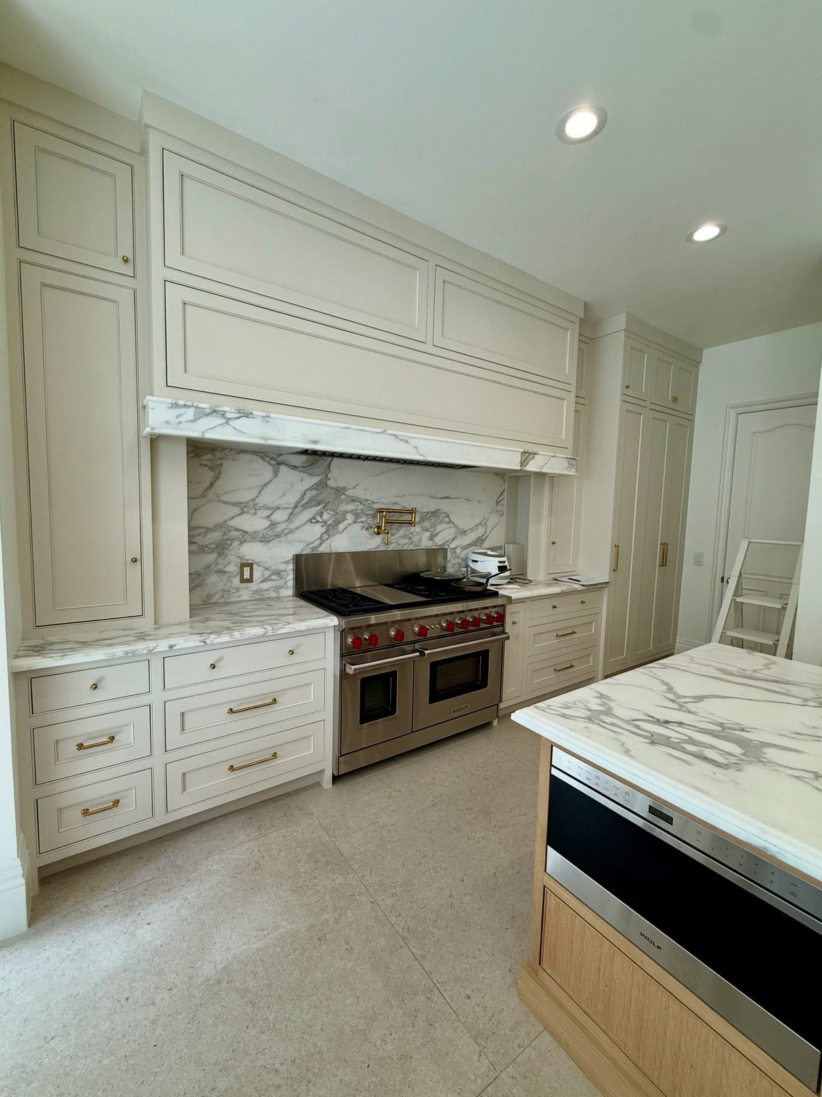 Newport Beach kitchen after remodel, Wolf range and marble backsplash
