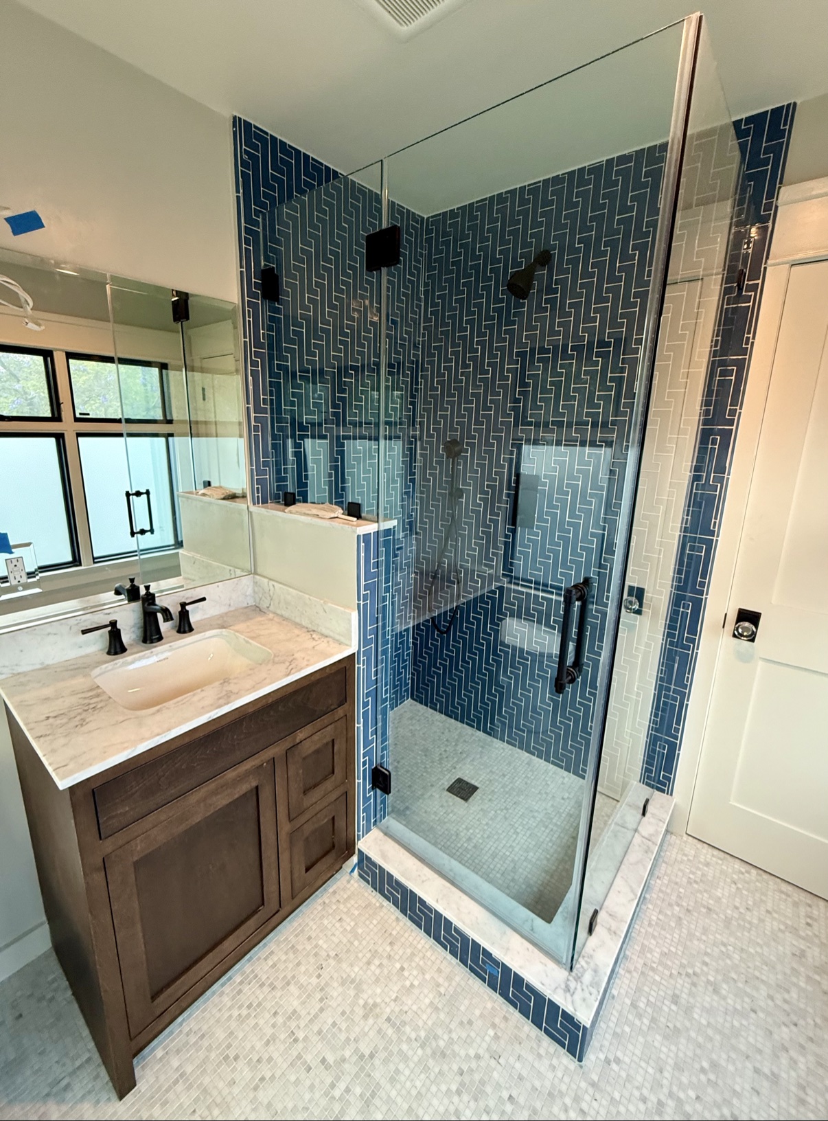 Shower with blue patterned tile